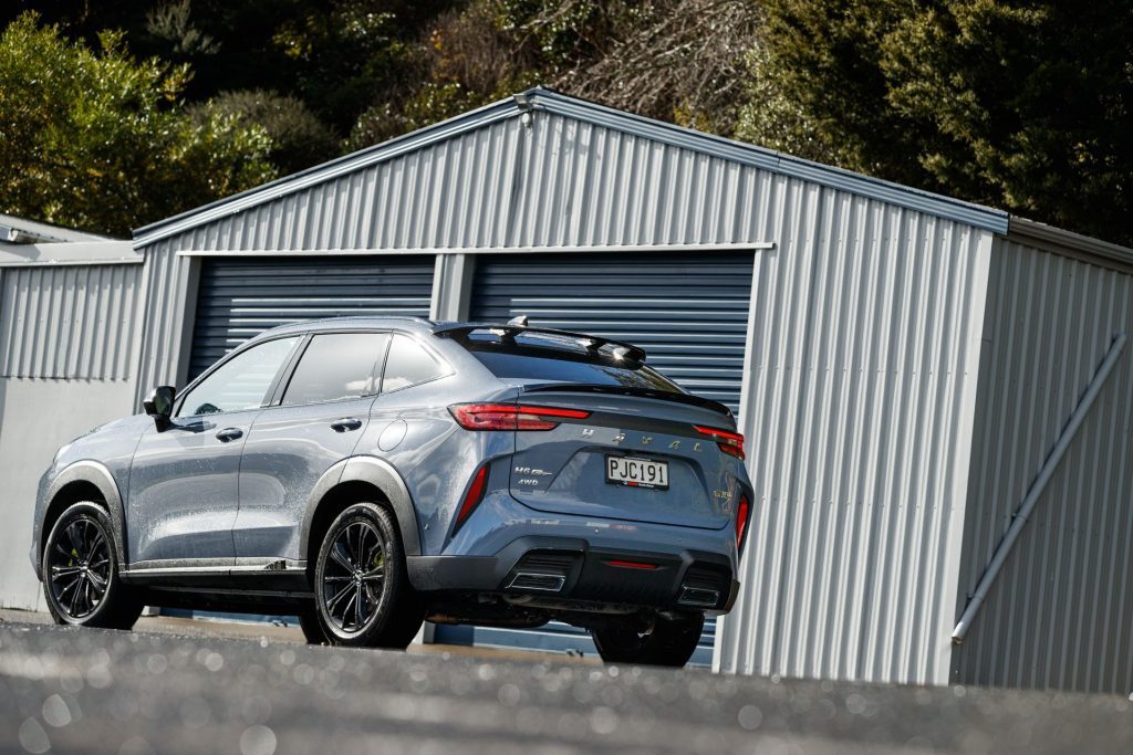 Haval H6GT in front of sheds
