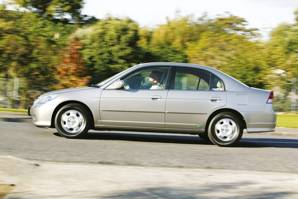 Honda Civic Hybrid driving past trees