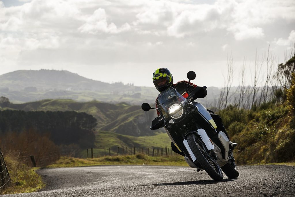 2022 Husqvarna Norden 901 riding uphill with rock formations in background