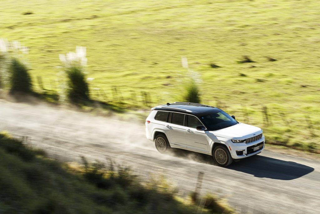 2022 Jeep Grand Cherokee L Summit Reserve driving fast on gravel road