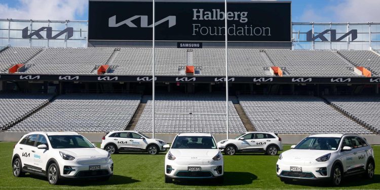 Kia Niro EVs in stadium in front of Halberg Foundation sign