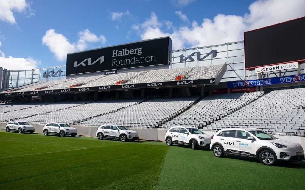 Kia Niro EVs in stadium in front of Halberg Foundation sign