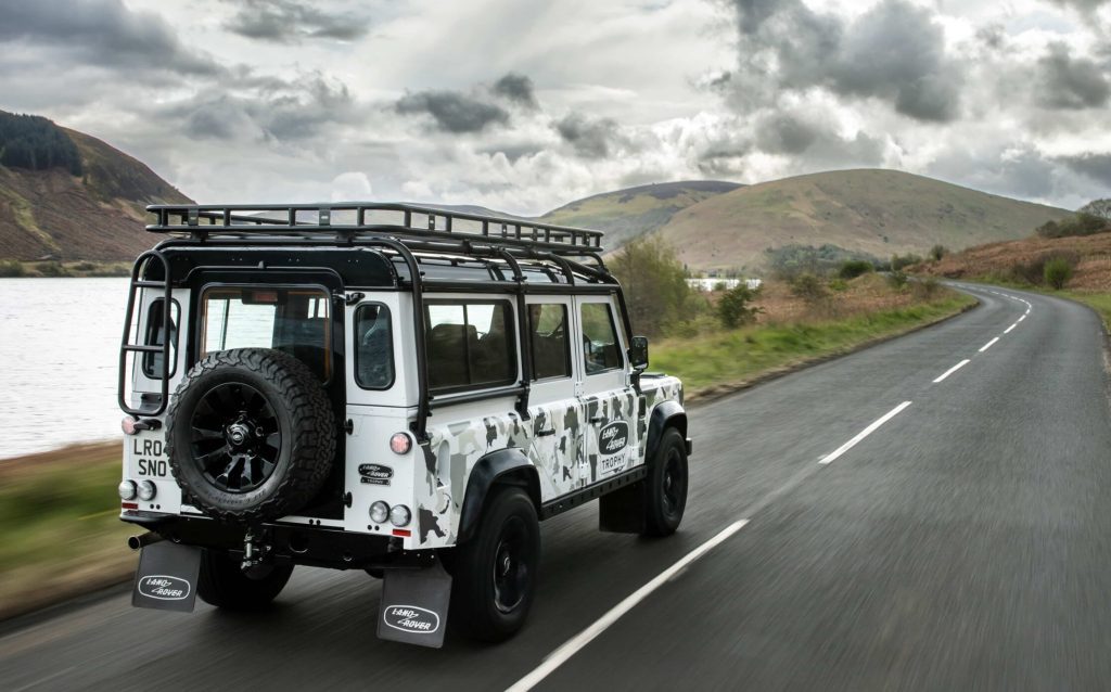 Land Rover Defender Works V8 Trophy II rear three quarters driving on road