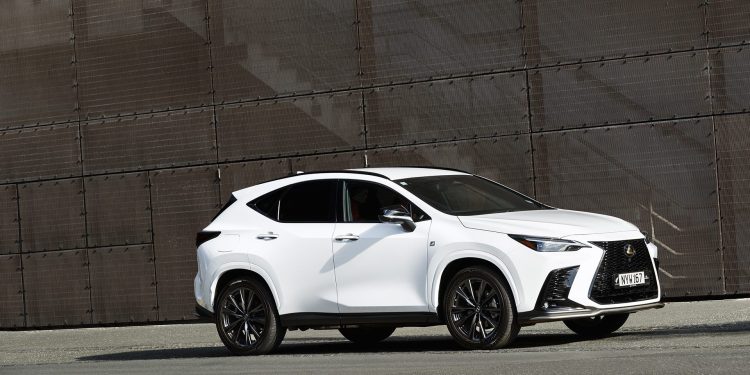 2022 Lexus NX 450h+ F Sport parked in front of metal wall