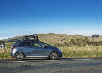 Long term test: 2022 Honda Jazz e:HEV Luxe with rioofbag parked in front of wind turbines