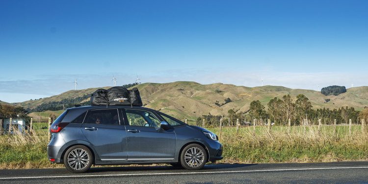 Long term test: 2022 Honda Jazz e:HEV Luxe with rioofbag parked in front of wind turbines