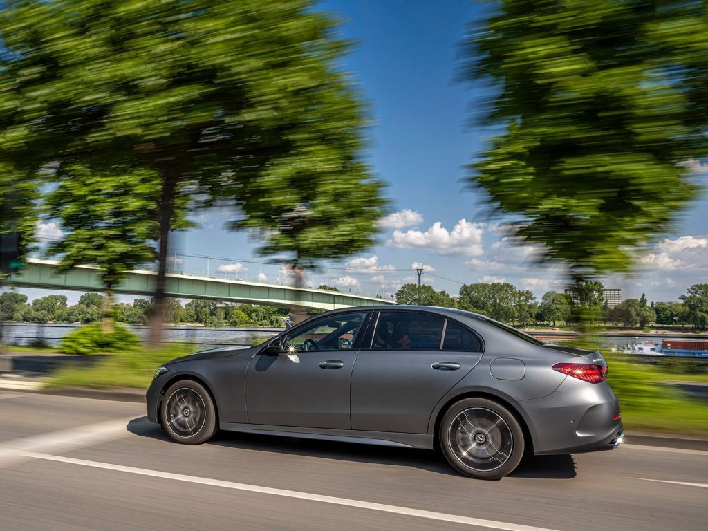 Mercedes-Benz C-350 e plug-in driving past river