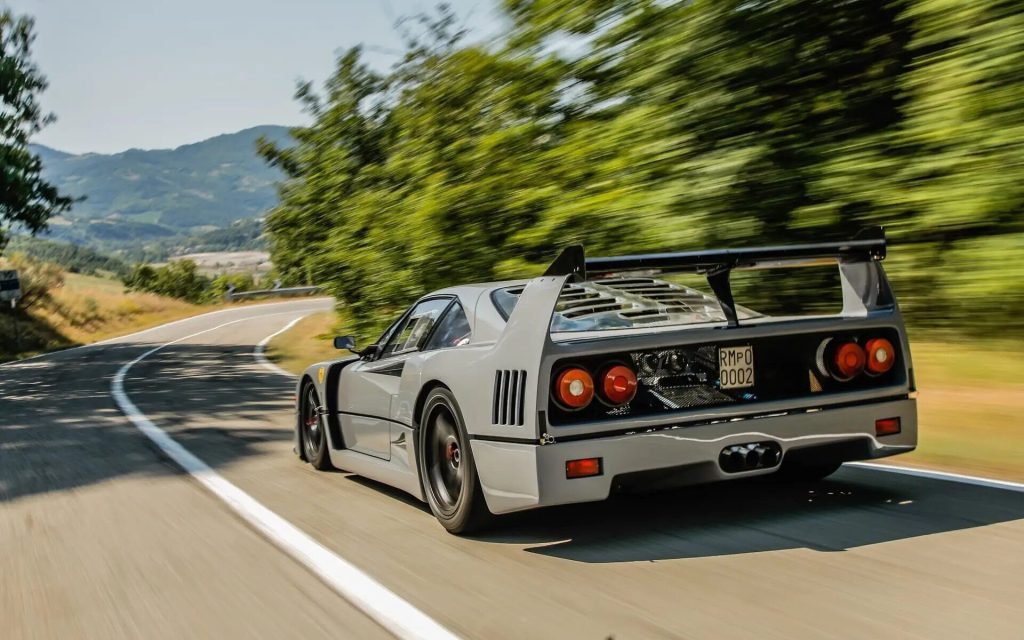 One-off Ferrari F40 Competizione rear three quarter view driving around corner