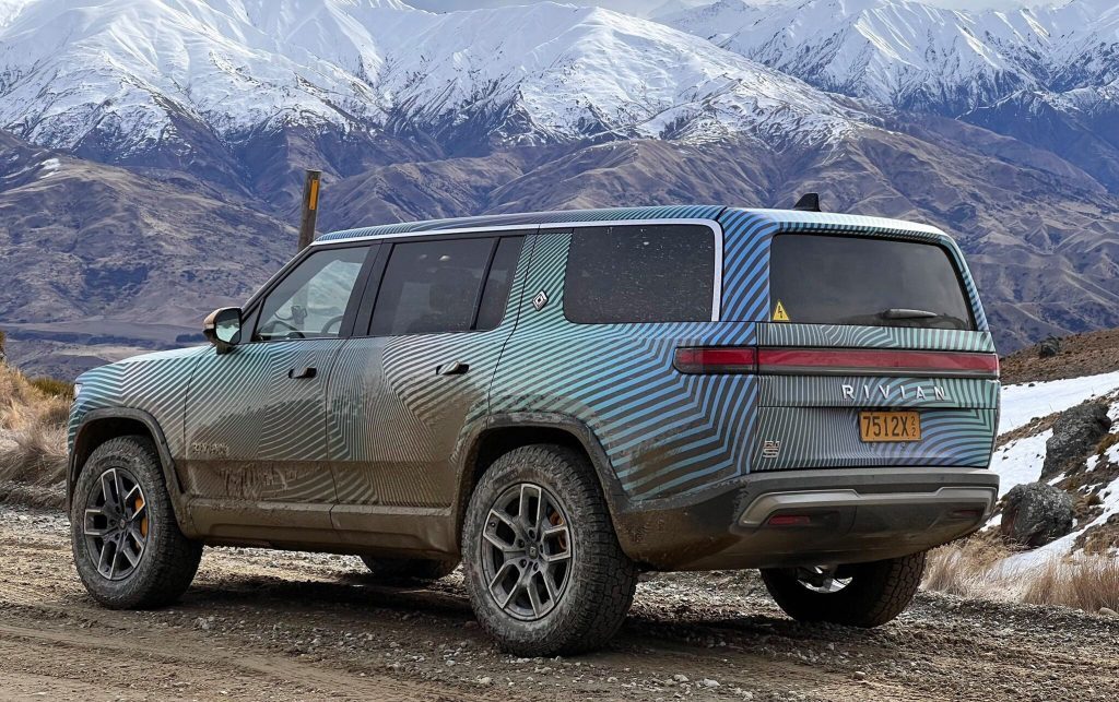 Rivian R1S rear three quarter view next to mountains in New Zealand