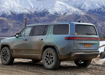 Rivian R1S rear three quarter view next to mountains in New Zealand