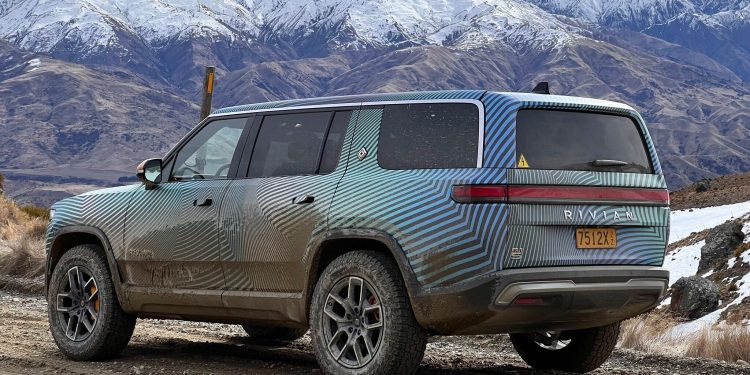 Rivian R1S rear three quarter view next to mountains in New Zealand