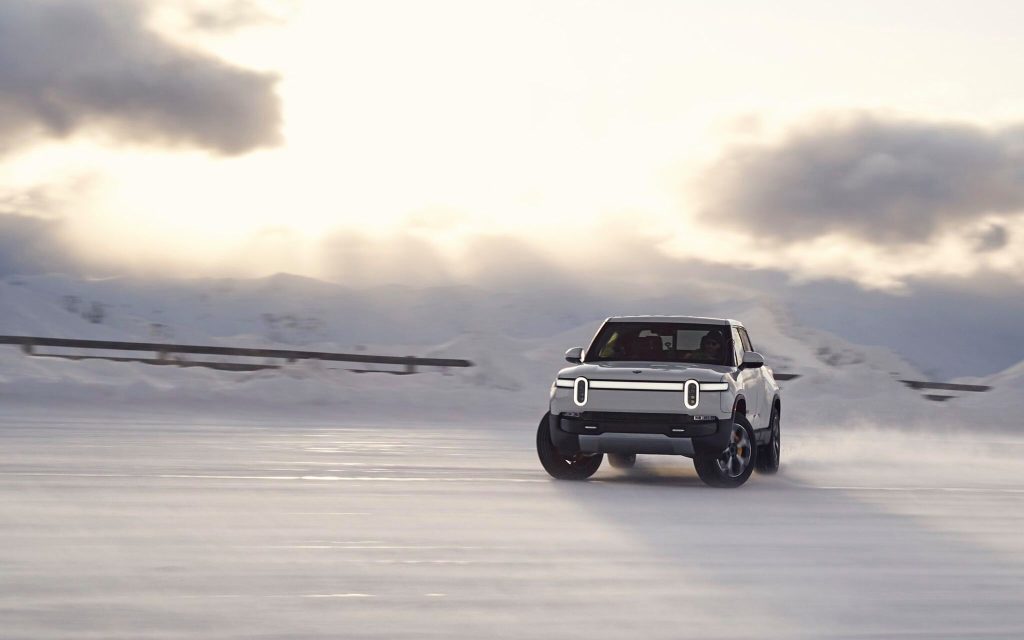 Rivian R1T front three quarter view drifting on snow