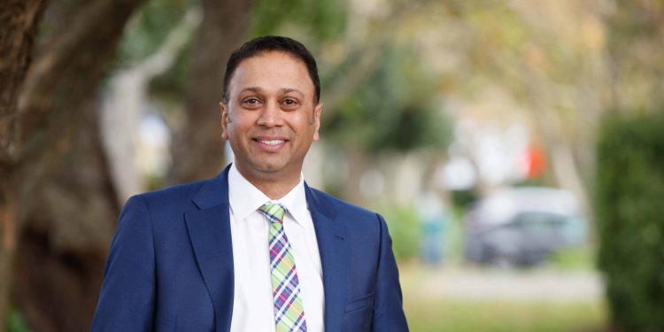 Toyota New Zealand CEO Neeraj Lala standing in front of trees