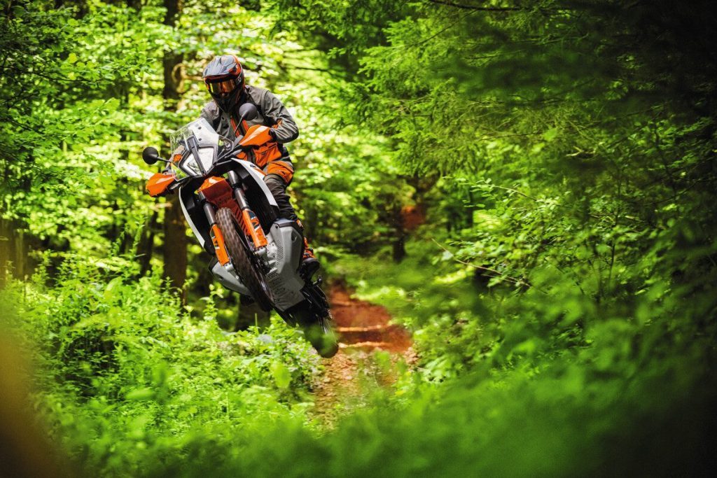KTM 890 Adventure R jumping in forest