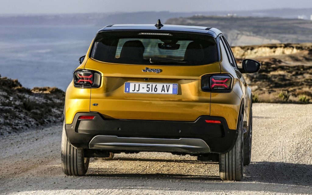 Jeep Avenger 4xe SUV rear view on gravel road