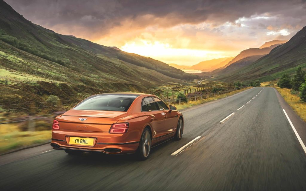 Bentley Flying Spur Speed rear three quarter view driving on road