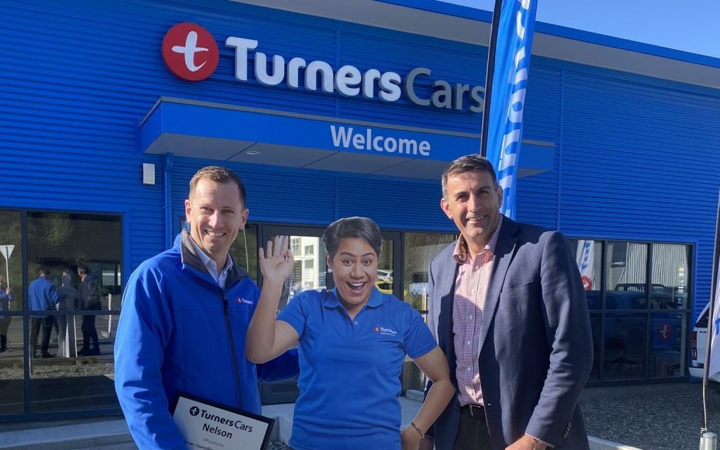 Two men standing in front of Turners car dealership