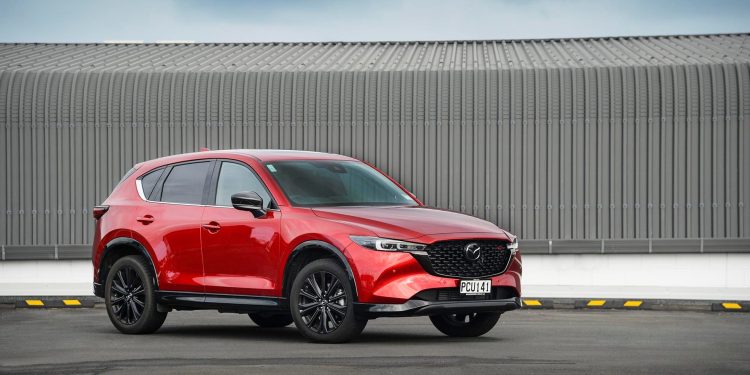 2022 Mazda CX-5 SP25T parked in front of corrugated iron wall