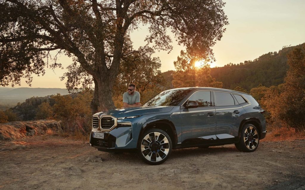BMW XM SUV side view by sunset