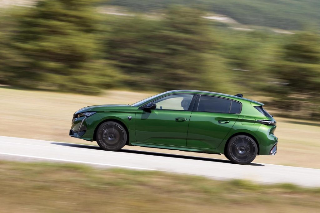 2022 Peugeot 308 driving past trees