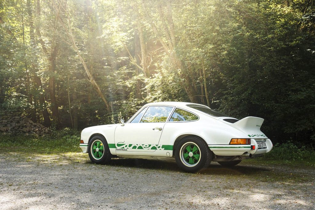1973 Porsche 911 2.7 Carrera RS parked in front of trees