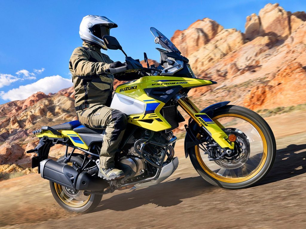 Suzuki V-Strom 1050 riding past rocks