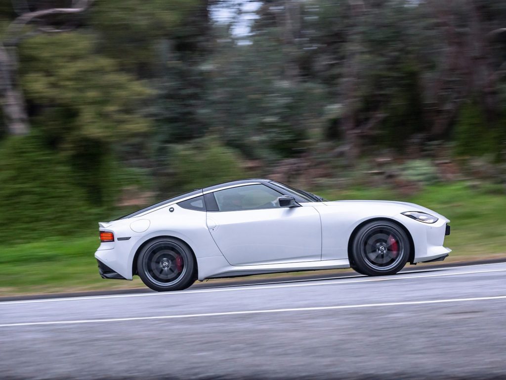 2022 Nissan Z driving past trees