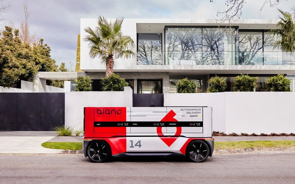 Applied EV autonomous delivery vehicle outside house
