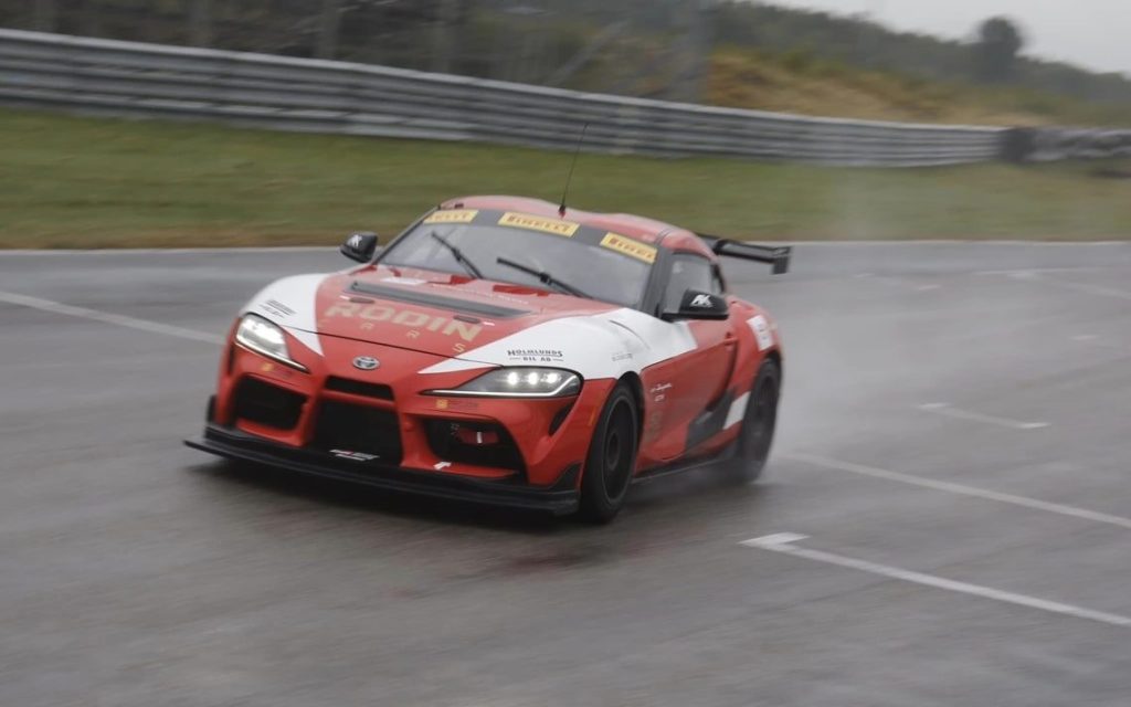 Toyota GR Supra GT4 racing in wet front three quarter view
