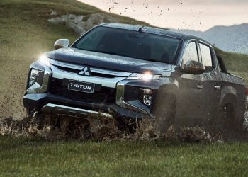 Mitsubishi Triton driving through mud off road front view