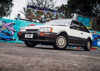 1986 Mazda Familia 4x4 DOHC Turbo in front of street art