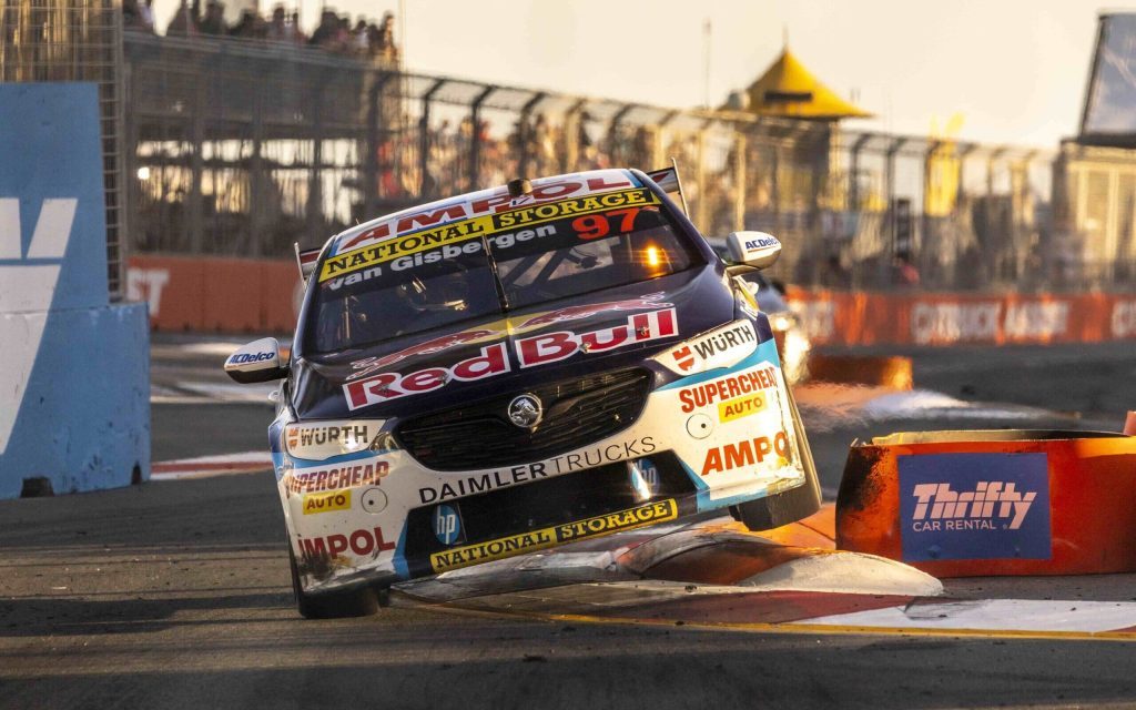 Shane van Gisbergen's Holden ZB Commodore racing over curb