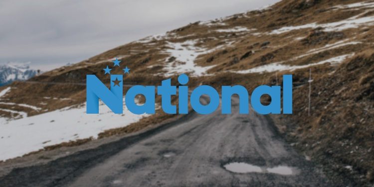 National logo over road with potholes
