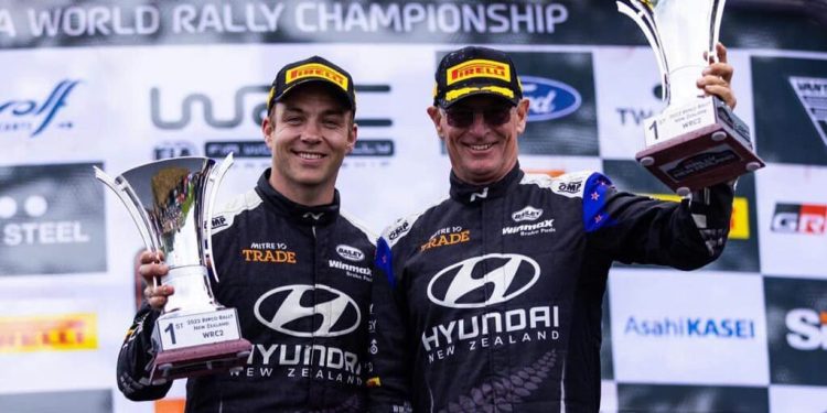 Hayden Paddon and John Kennard holding up trophies