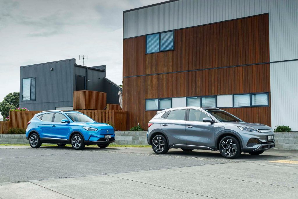 2022 BYD Atto 3 Extended vs 2022 MG ZS Essence EV side shot in front of houses