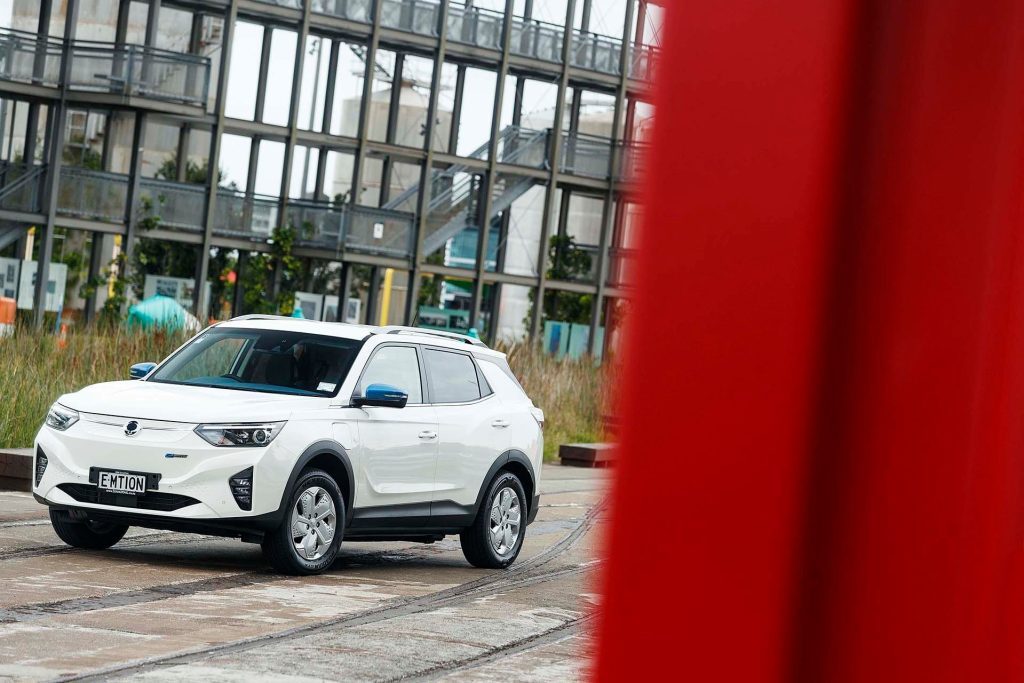 SsangYong Korando e-Motion front static in front of metal structure