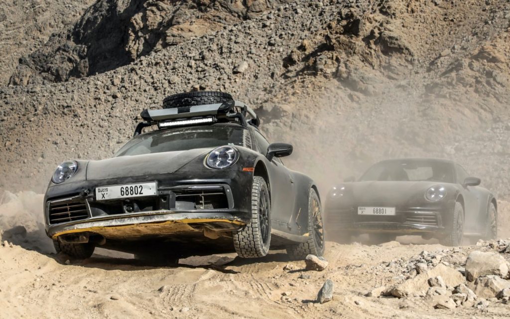 Porsche 911 Dakar pair driving over rocks