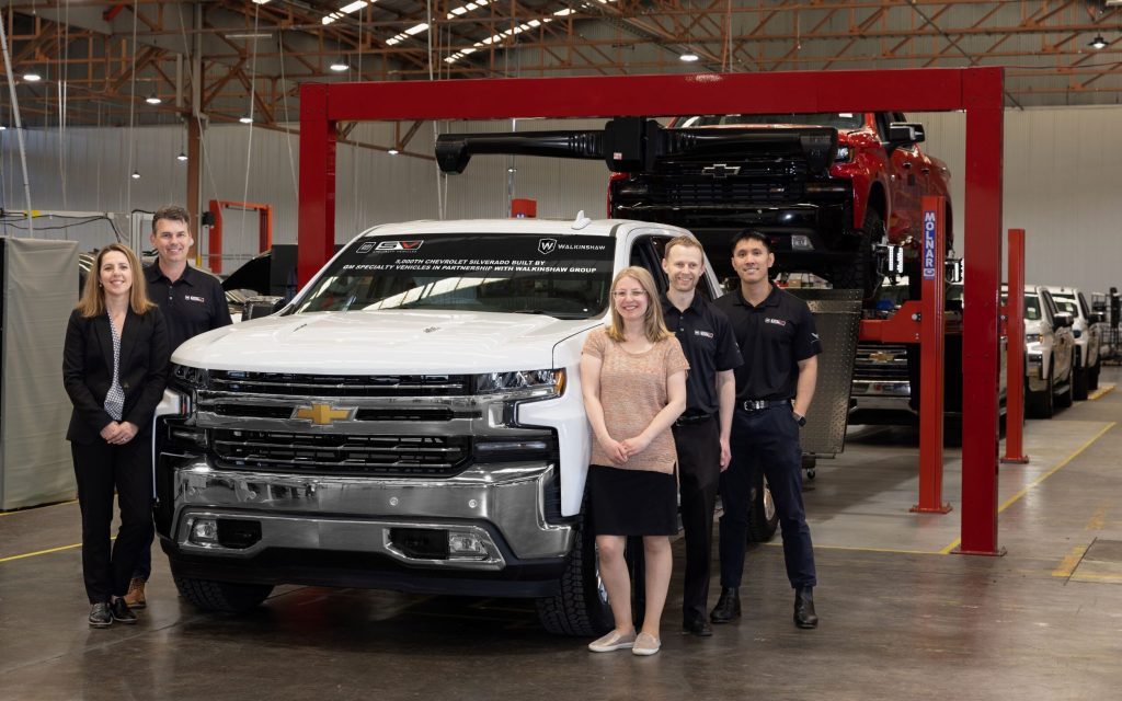 GMSV workers standing next to Chevrolet Silverado remanufacturing line