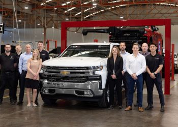 GMSV workers standing next to Chevrolet Silverado remanufacturing line