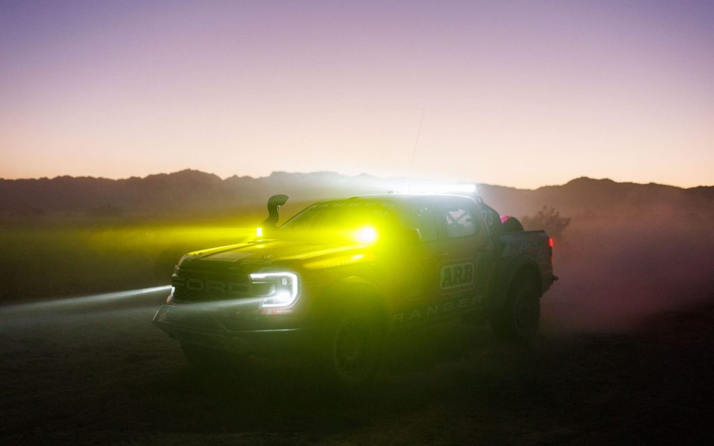Ford Ranger Raptor Baja racer at night in dust