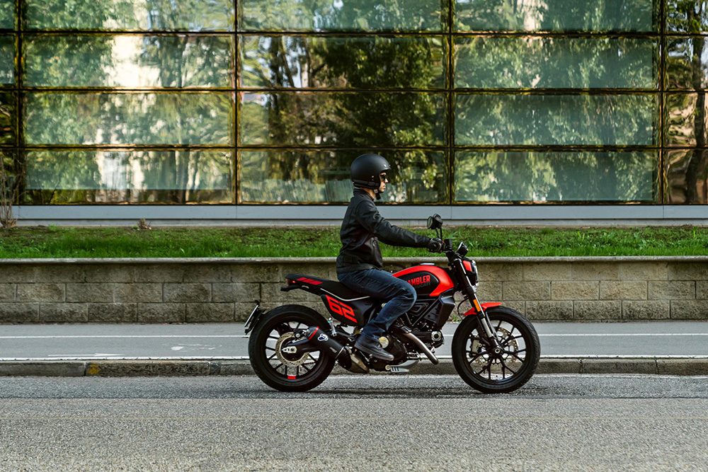 Ducati Scrambler riding past windows