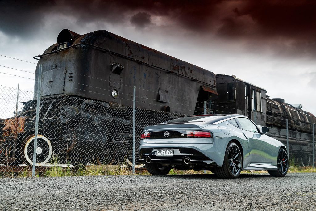 Nissan Z Coupe in front of train