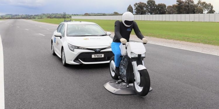 Toyota Corolla behind bike safety dummy