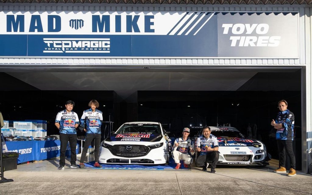 Mad Mike Whiddett's Mazda3 hillclimb car front view with team