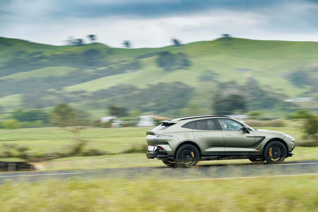 Aston Martin DBX707 driving past hills