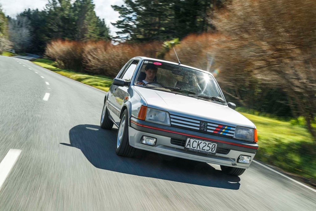 Peugeot 205 GTi tracking on twisty road