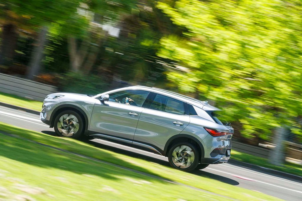 BYD Atto 3 Extended Range driving past trees