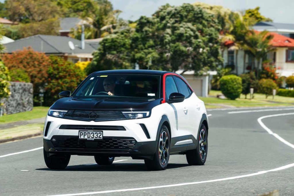 Opel Mokka-e SRi driving through suburbs