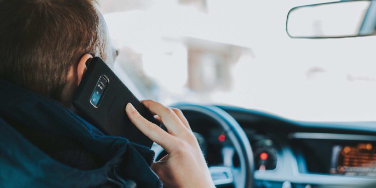 Man using phone while driving