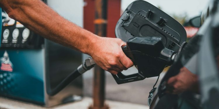 Person filling car up with fuel